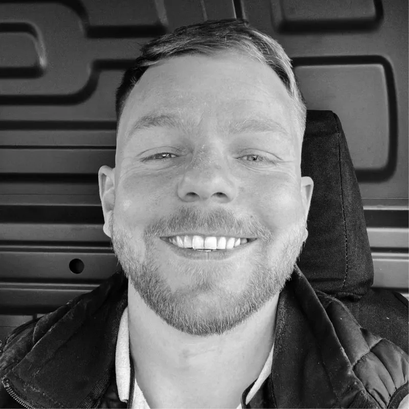 George Gilfoyle, owner of Gilfoyle Electrical Services, smiling in the cab of his van.