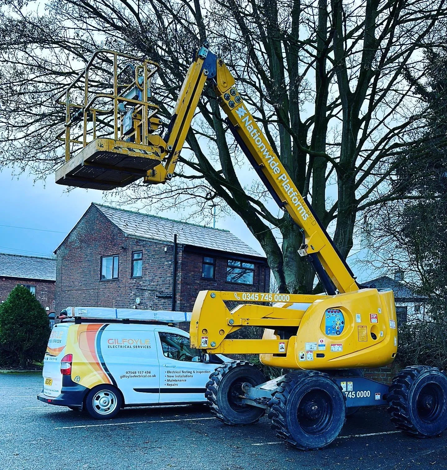 The Gilfoyle Electrical van parked beside a hired boom lift for work at height.